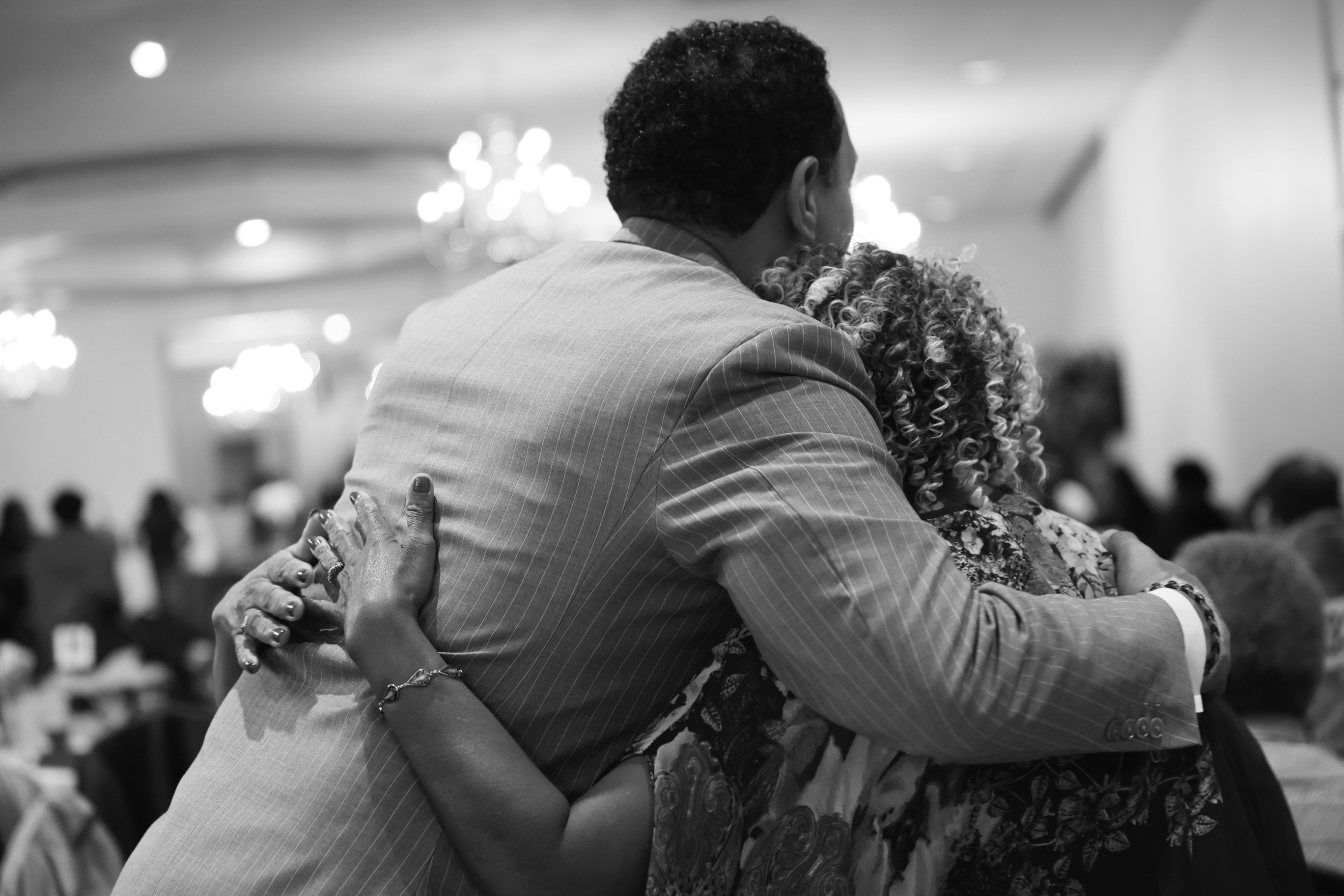 Ivan J. Bates embracing a community member.