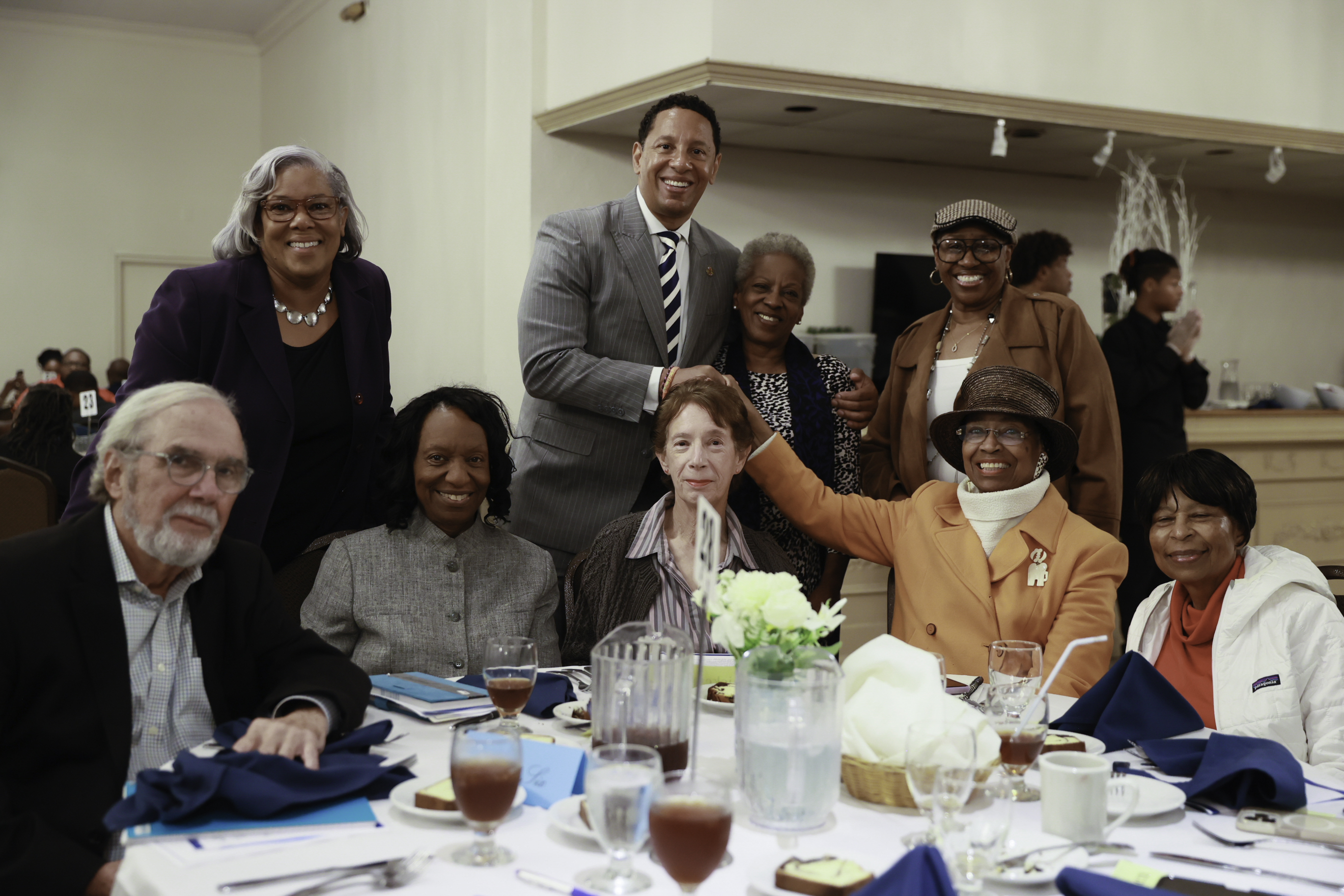 State's Attorney Ivan J. Bates with community members at a banquet.